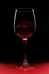 glass of red wine on black background