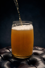 glass of beer with foam on white background