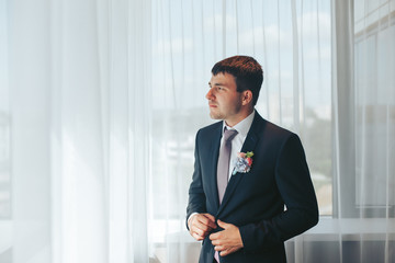 A young handsome man is preparing for his wedding. Morning groom