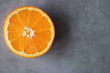 Slice of orange  on gray background. Citrus fruit.