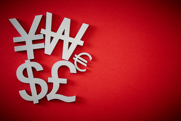 Currency symbols on red background