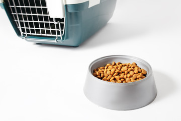 Plastic carrier and food bowl for dogs and cats isolated on white. Diet and proper nutrition of Pets concept