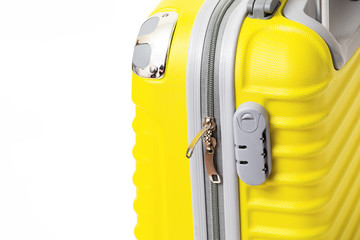 Close-up of a yellow modern travel suitcase with code zip lock