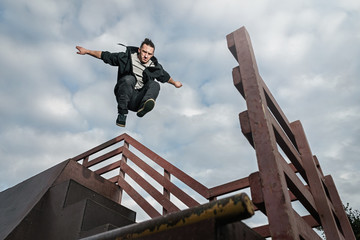 Man doing parkour in city. Athlete practicing freerunning.