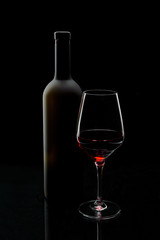 glass of red wine and bottle