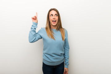 Blonde woman on isolated white background intending to realizes the solution while lifting a finger up