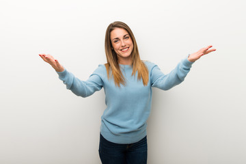 Blonde woman on isolated white background presenting and inviting to come with hand