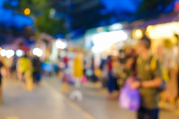 Abstract blurred people walking on market with light of bokeh