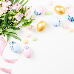 Festive Happy Easter background with decorated eggs, flowers, candy and ribbons in pastel colors on white. Copy space