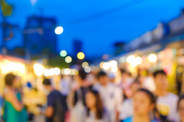 Abstract blurred people walking on market with light of bokeh