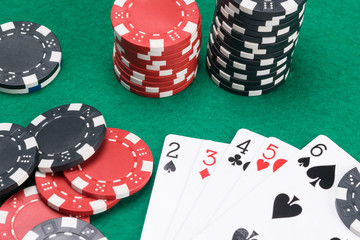 playing cards and a big win in poker on a green playing field