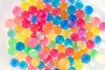 Fototapeta na wymiar Water coloured gel balls. Polymer gel. Silica gel. Balls of blue hydrogel. Crystal liquid ball with reflection. Texture background. Close up macro