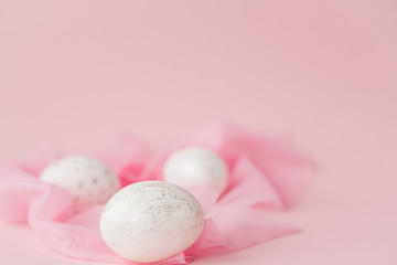 White Easter eggs on pink background with copy space. Top view shot of arrangement decoration Happy Easter holiday background concept. Design pastel tone in minimal flat lay