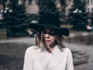 girl in a hat walks on a sunny day
