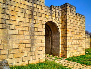 Solid stone wall and entrance of ancient fortress