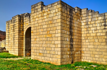 Solid stone wall and entrance of ancient fortress