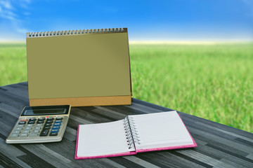 book note ,smart phone on office table with nature view.