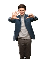 Fototapeta premium Teenager man with turtleneck counting six with fingers over isolated white background