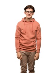 Teenager man with sweatshirt with glasses and happy over isolated white background