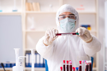 Young handsome chemist working in the lab 