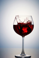 Pouring red wine into glass 
