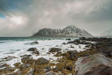 Rocks falling into the sea near Skagsanden beach. Lofoten islands, Norway