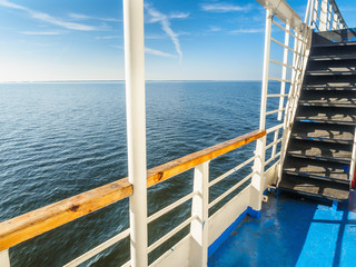 Fototapeta na wymiar View from deck of a motor ship at the sea and blue horizon on a sunny summer day