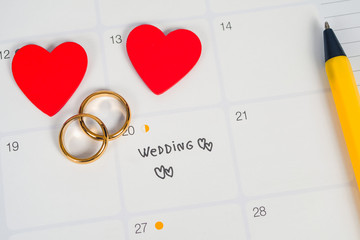 Word Wedding to Reminder Wedding day with Wedding ring on calendar planning and office tool.
