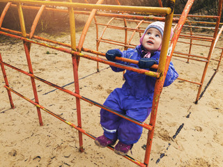 little child climbing on ladder at playground
