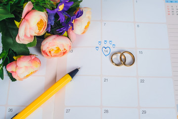 Word Wedding to Reminder Wedding day with Wedding ring on calendar planning and office tool.