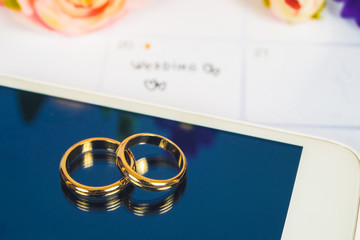 Wedding ring on screen of smart phone love concept.
