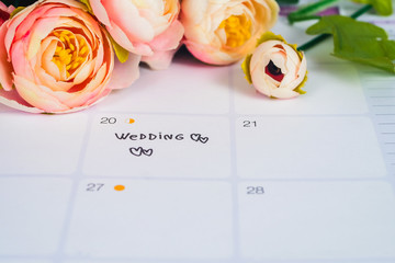 Word Wedding to Reminder Wedding day in calendar planning and pen with heart.