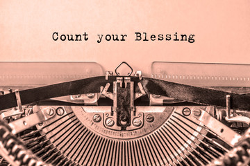 Count your Blessings printed on a sheet of paper on a vintage typewriter. journalist, writer.