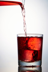 Pouring red wine into glass 