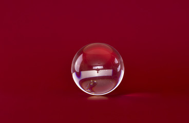 magic glass ball isolated on red background