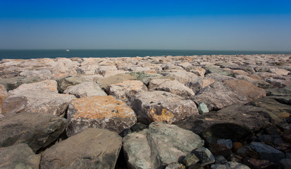 Fototapeta na wymiar big bloulders rocks near the sea