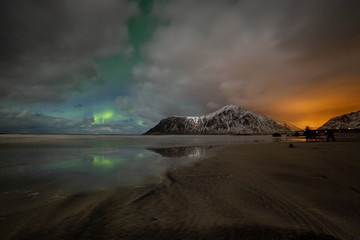 Photographers with tripods during aurora borealis hunting at Skagsanden beach. Lofoten Islands, Norway, Scandinavia
