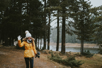 Young woman with camera in the forest