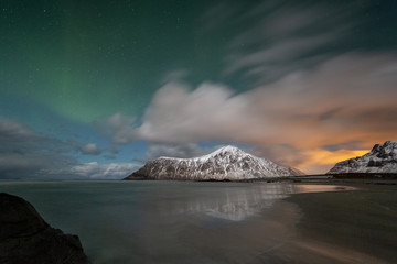 Photographers with tripods during aurora borealis hunting at Skagsanden beach. Lofoten Islands, Norway, Scandinavia