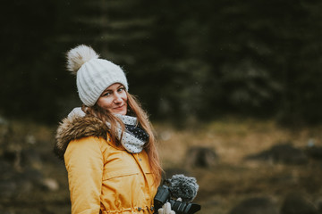 portrait of young woman with camera in forest