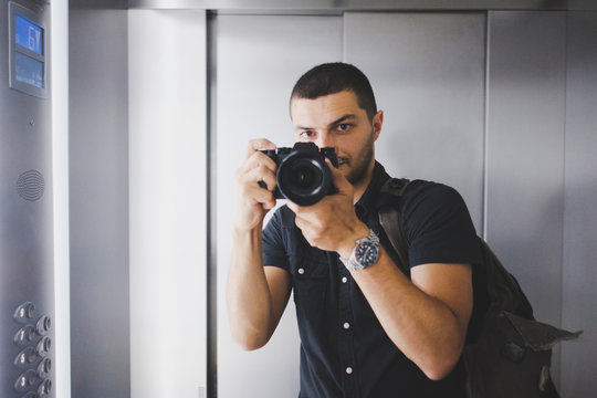 young man with a camera in mirror