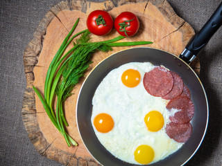 fried eggs, tomatoes and green onions