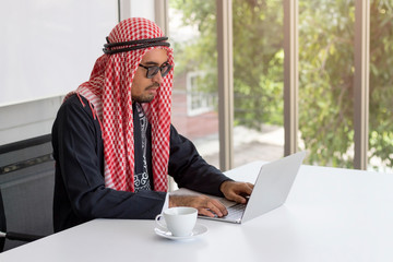 Business concept; Arabian businessman working with computer for communication in modern office