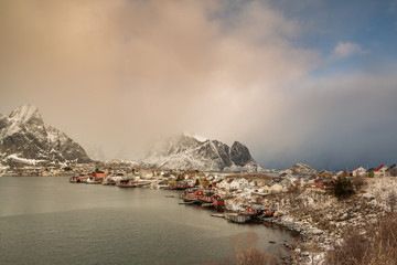 Beautiful traditional fishing red rorbuer huts in Reine village during the sunrise. Lofoten Islands, Norway, Scandinavia