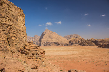 Fototapeta na wymiar Middle East picturesque bare mountain ridge and big sand valley desert scenery landscape travel photography 