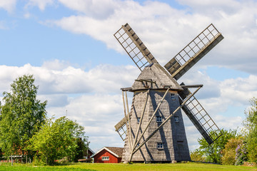 Fototapeta na wymiar Windmill at a farm in a rural landscape