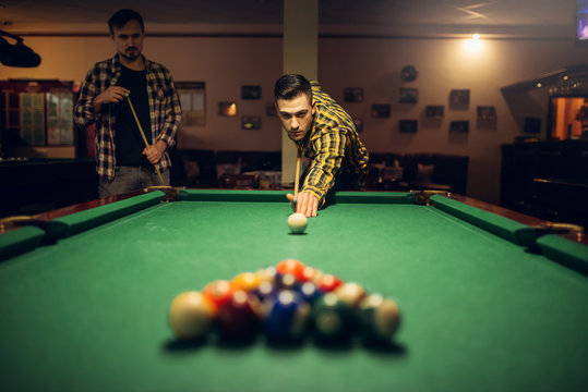 Male Billiard Player With Cue Aiming At The Table