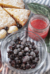 Frozen currant berries in a glass bowl.