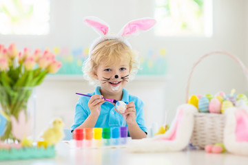 Kids on Easter egg hunt. Children dye eggs.