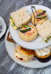 Afternoon tea with sandwiches and cakes